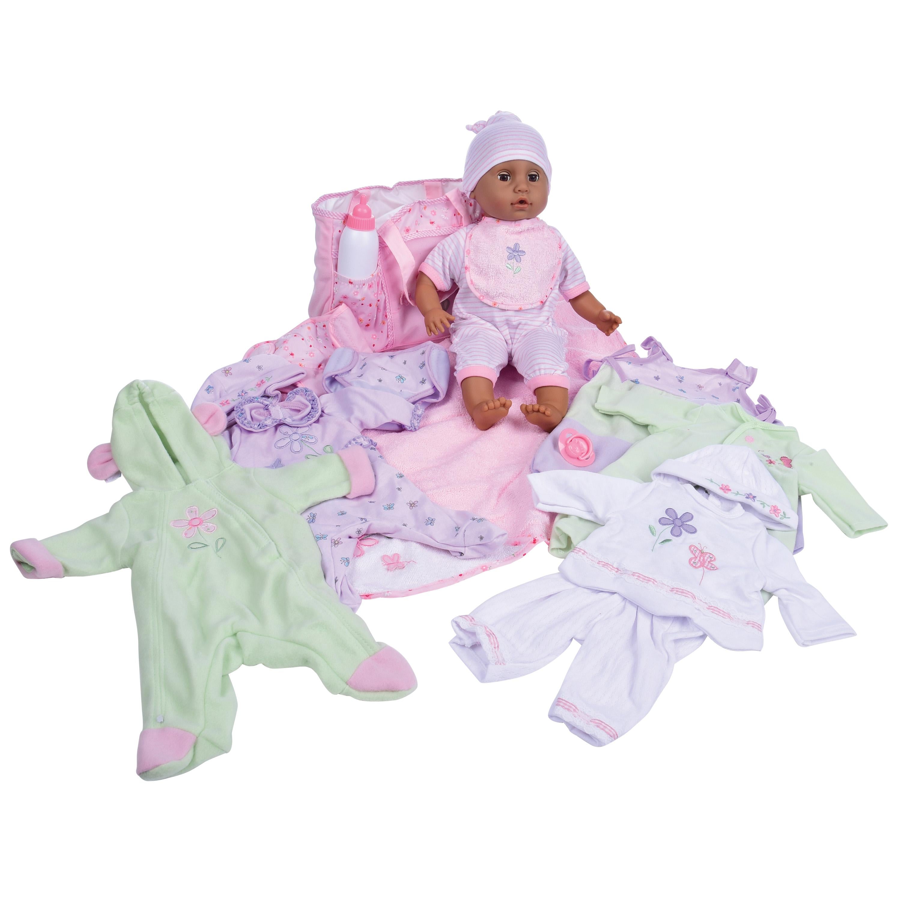 Baby doll with pink outfit and surrounding baby clothes on a white background