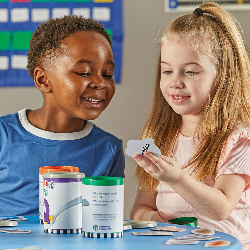 Two Kids in Classroom Learning with Alphabet Soup Game