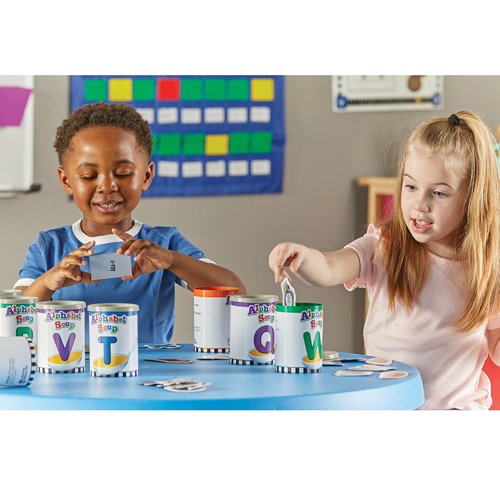 Two Kids in Classroom Playing Alphabet Soup
