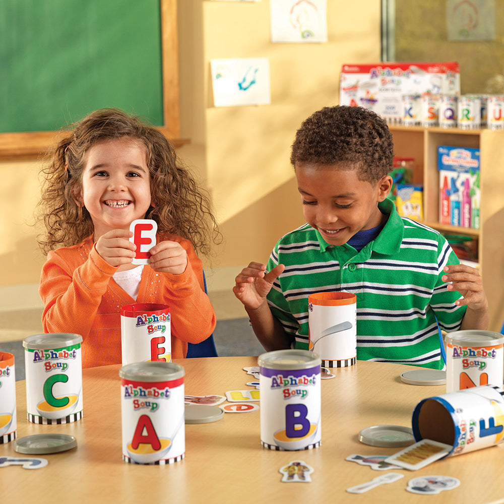 Two Kids in Classroom Engaging in Cooperative Play with Alphabet Soup Game