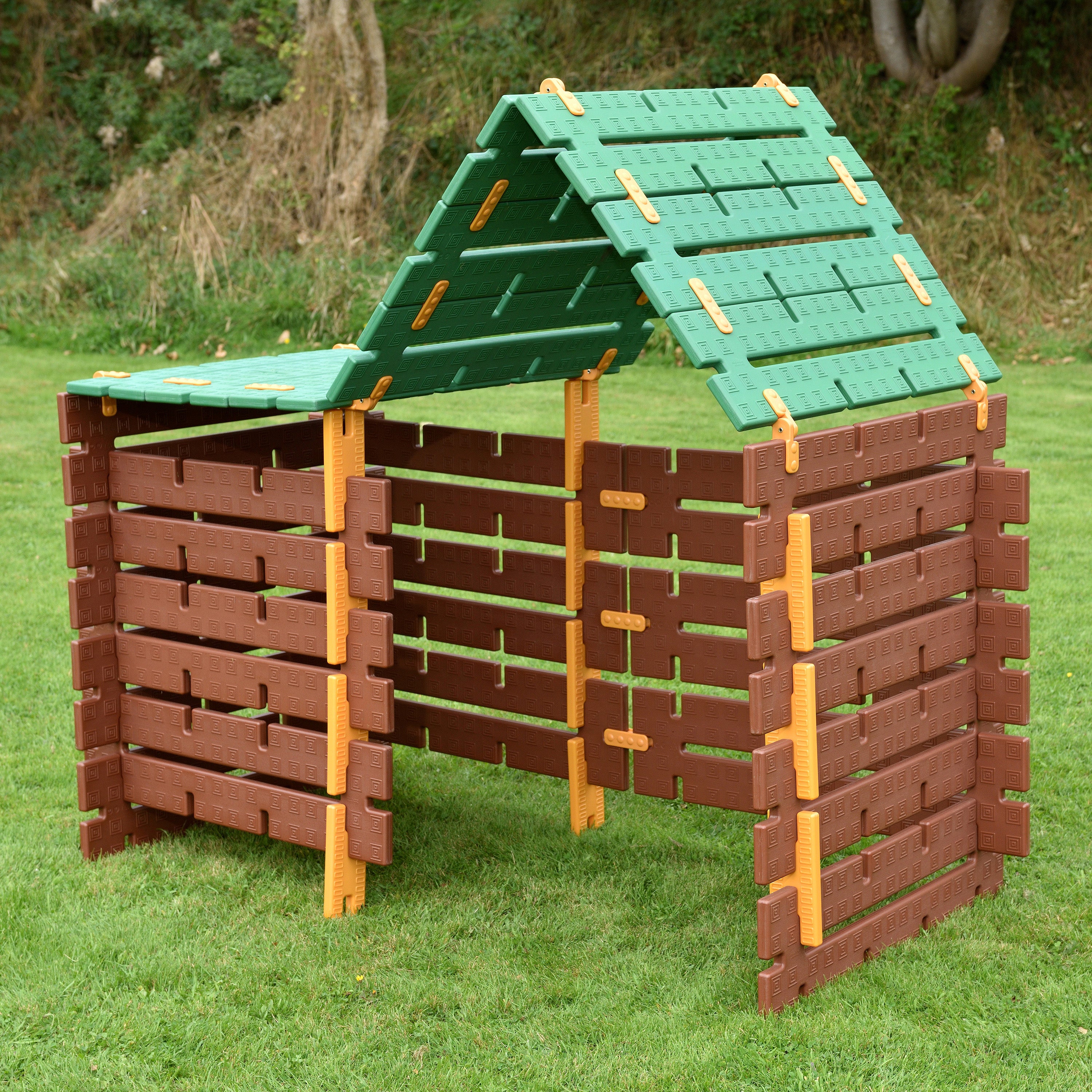 Plastic playhouse with green roof on grass