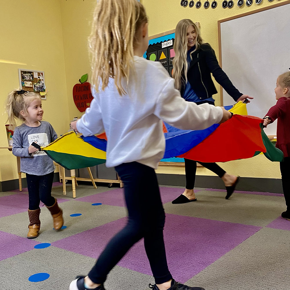 Teacher with Students in Classroom Engaging with Play Parachute