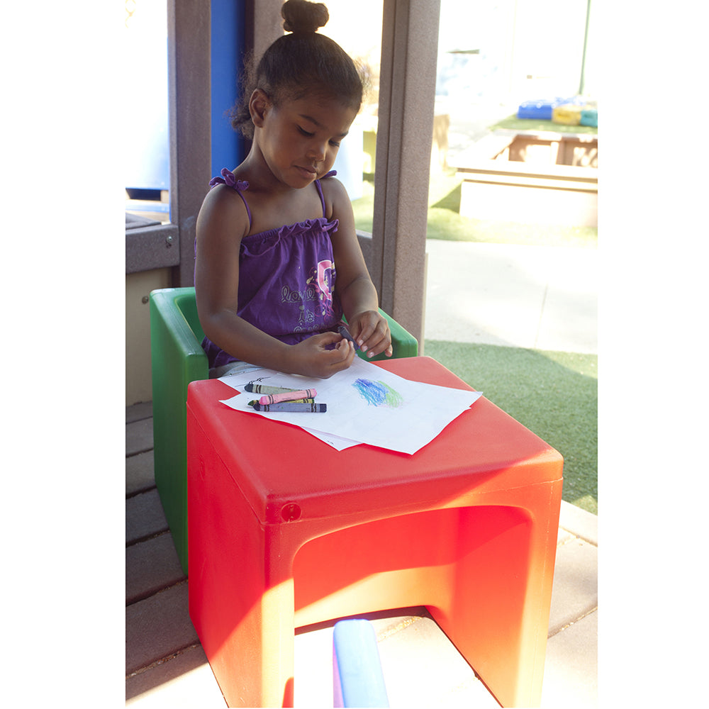 Kid Using Red Cube Chair as Table