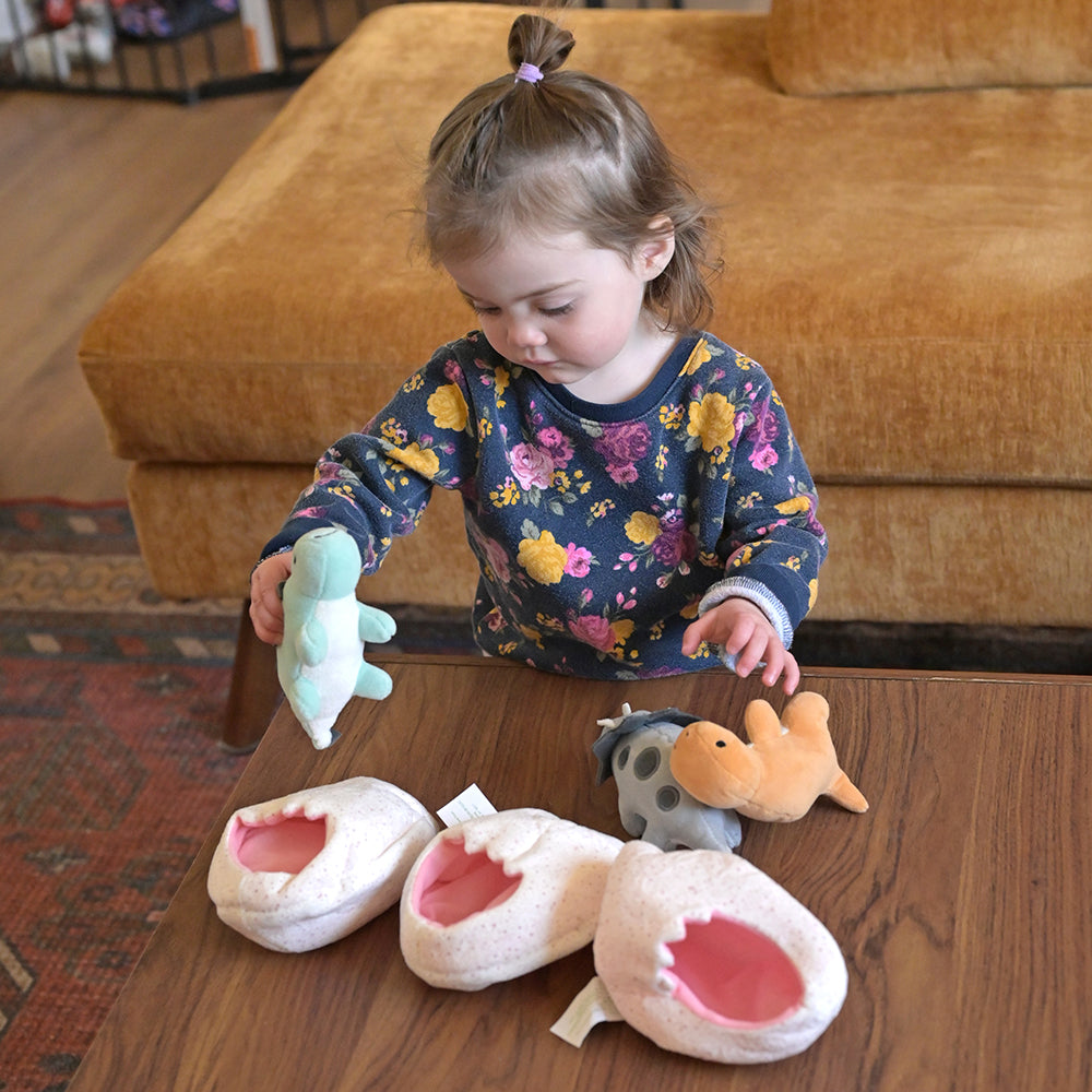 Toddler with Three Plush baby Dinos & Eggs