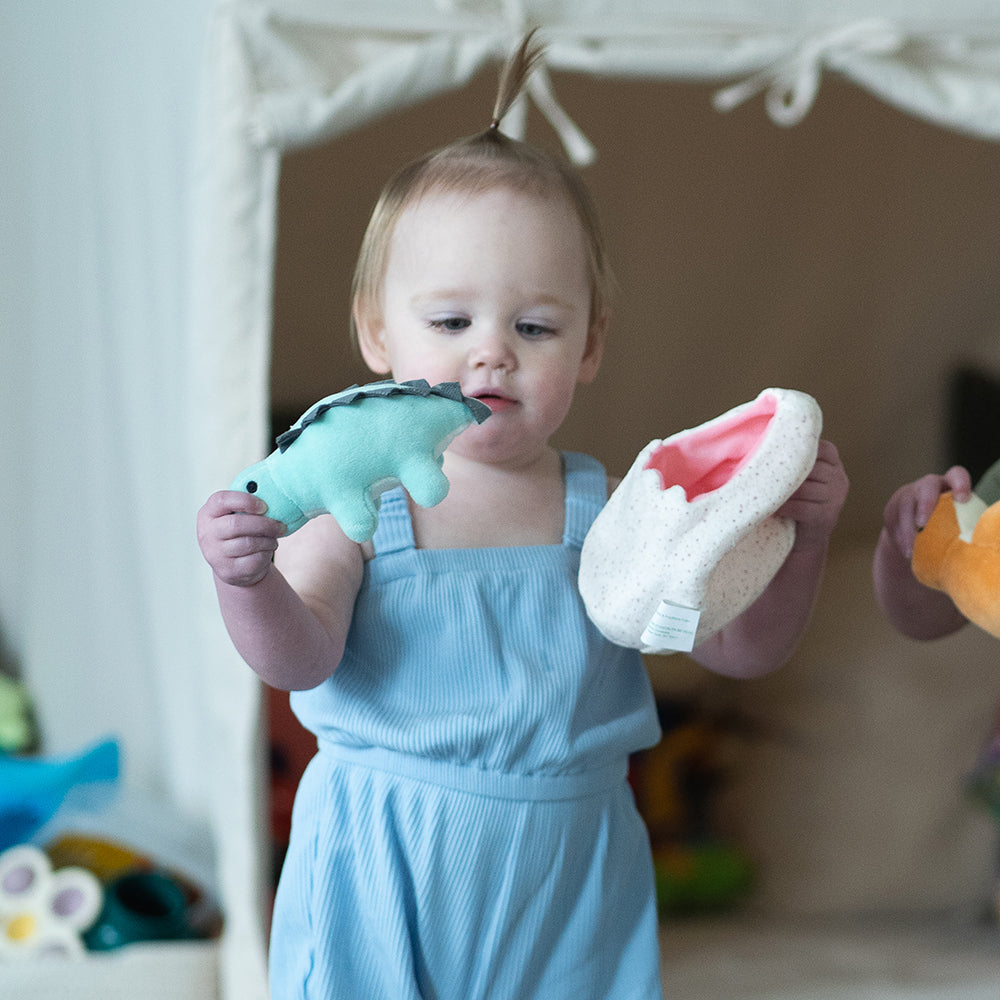 Baby Engaging with Plush Stegosaurus and Plush Egg