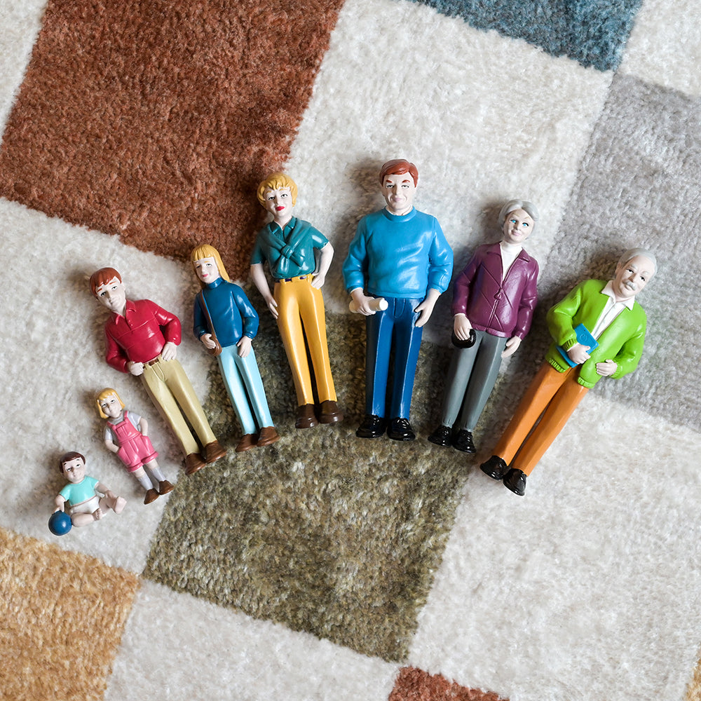 Caucasian Family Figurines Lined Up In Ascending Order