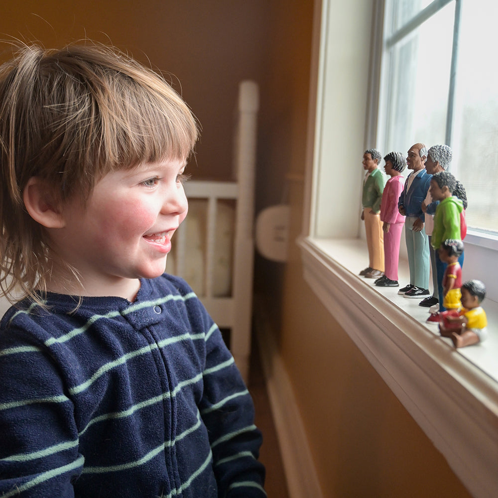 African American Pretend Play Vinyl Family Figurines Lined Up on Windowsill