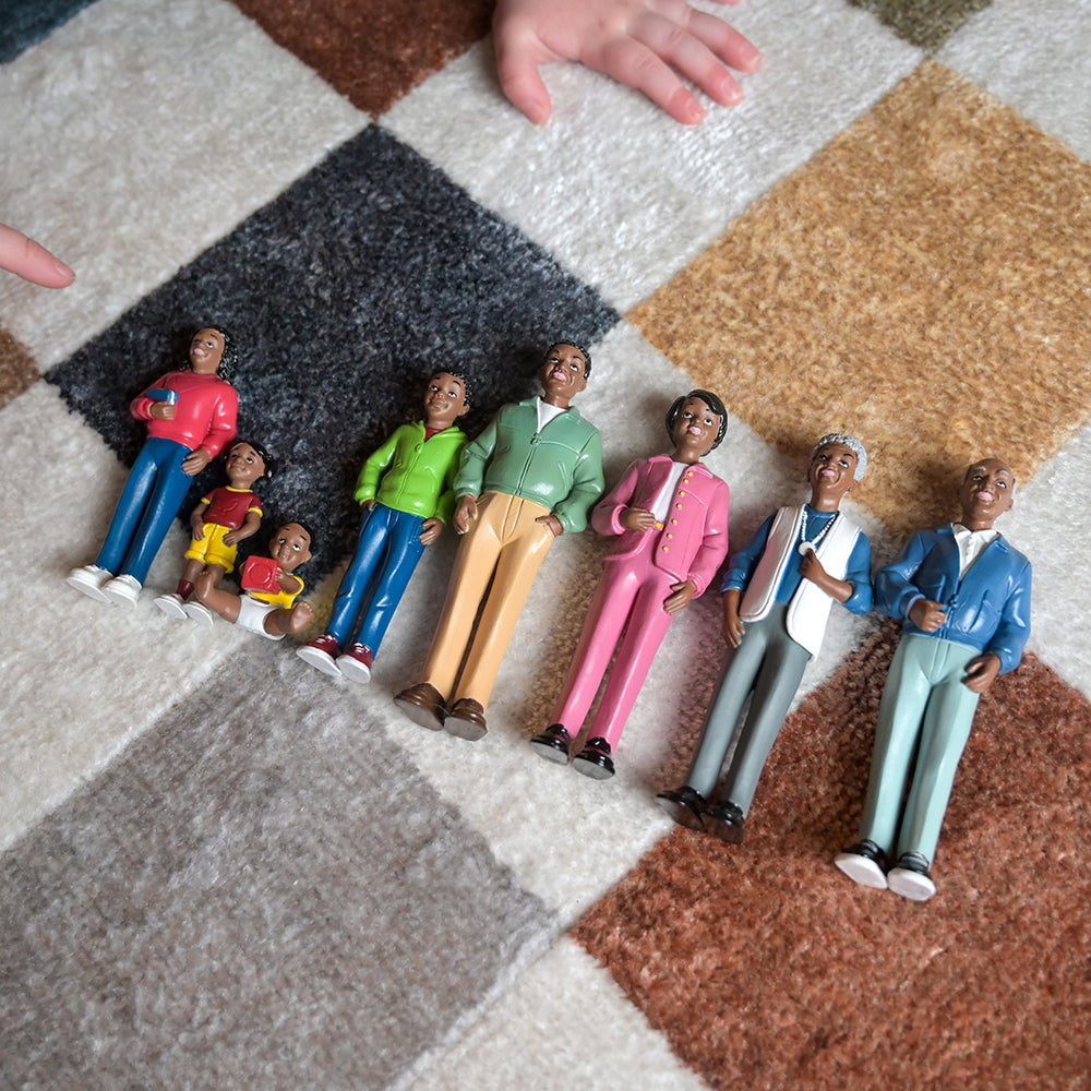 African American Pretend Play Vinyl Family Figurines Lined Up on Carpet