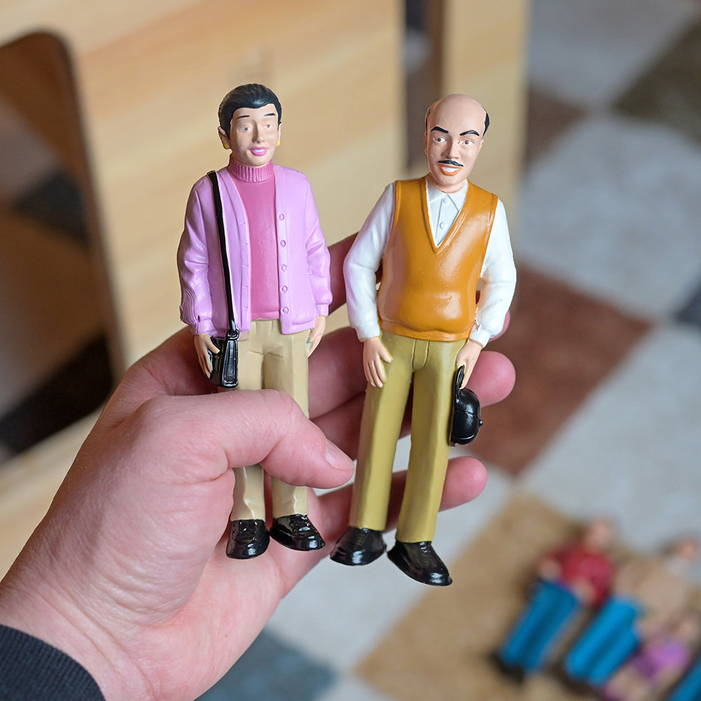 Grandma & Grandpa Hispanic Family Figurines in Teacher's hand