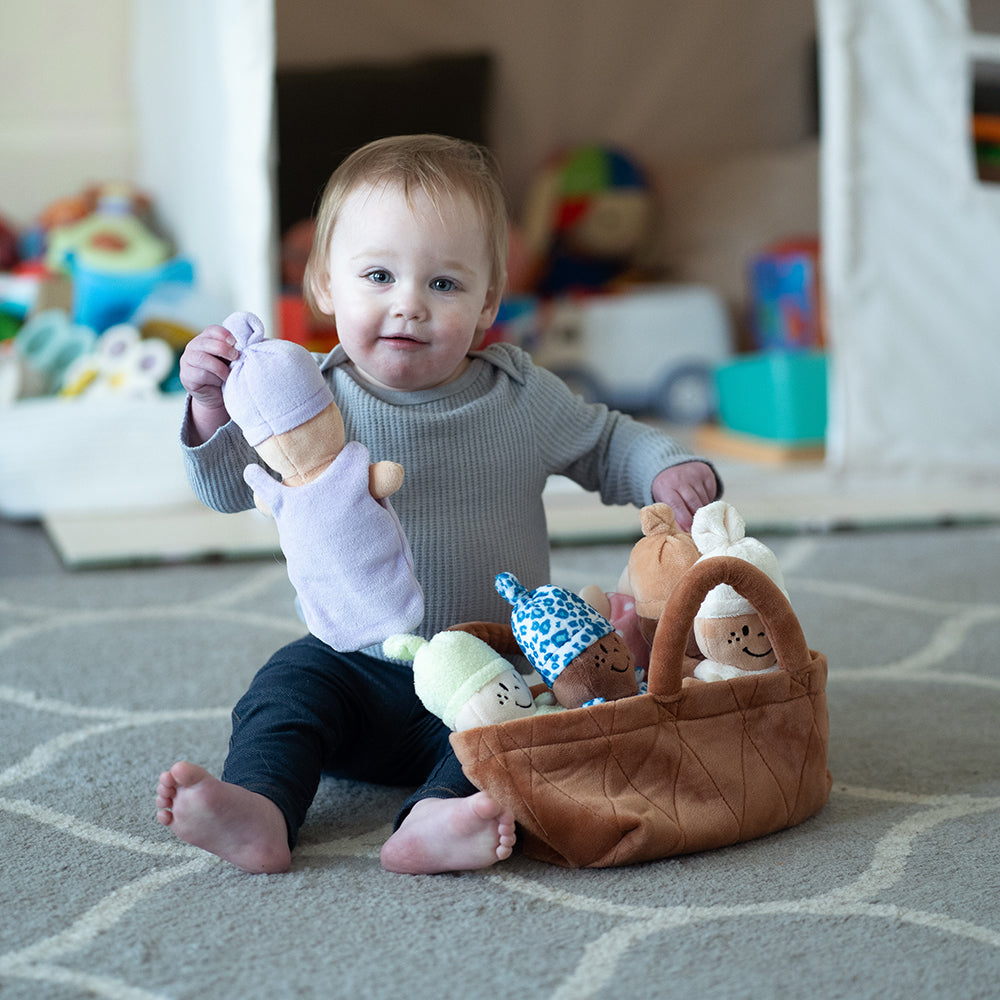 Baby Exploring Basket of Dolls