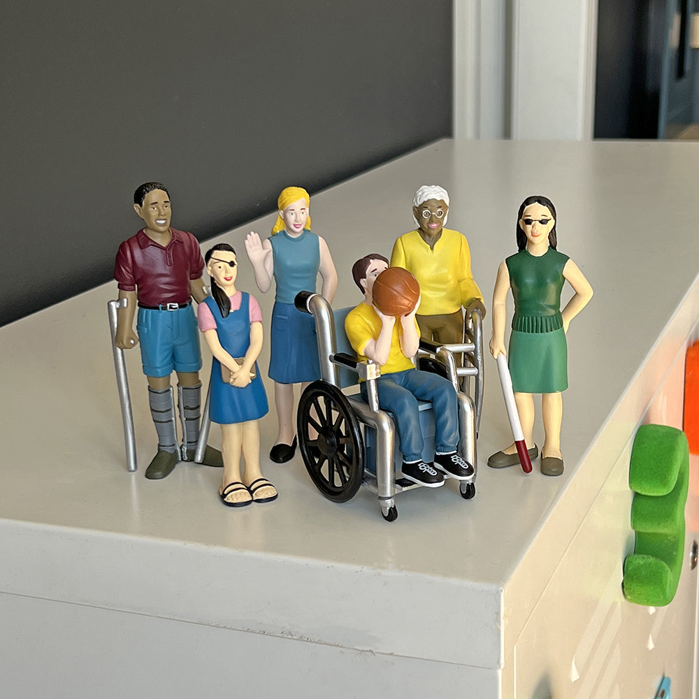 Inclusive Friends with Diverse Abilities Vinyl Figure Set on Top of a File Cabinet