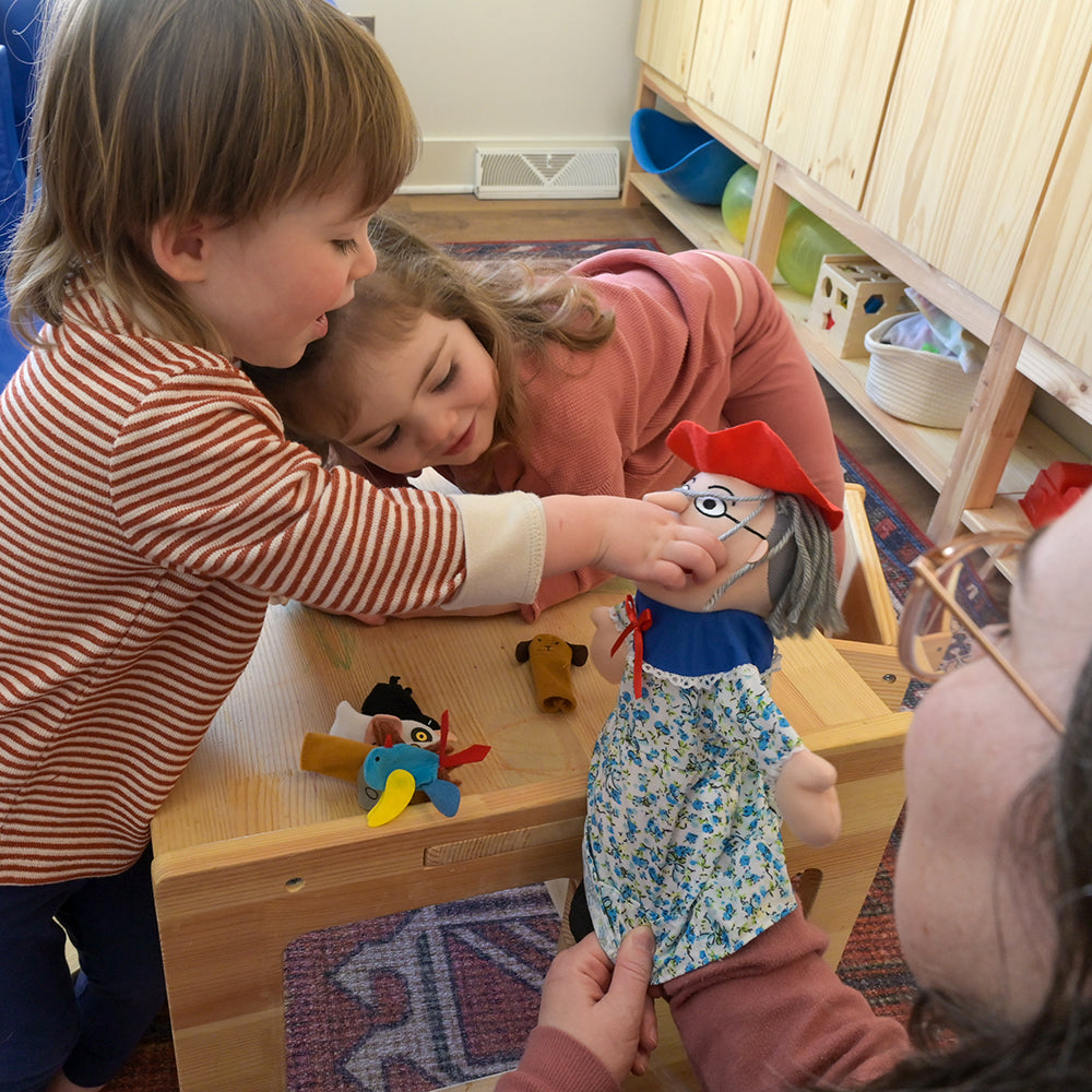 Adult & Two Toddlers Interacting with There Was an Old Lady Storytelling Puppet & Props Set