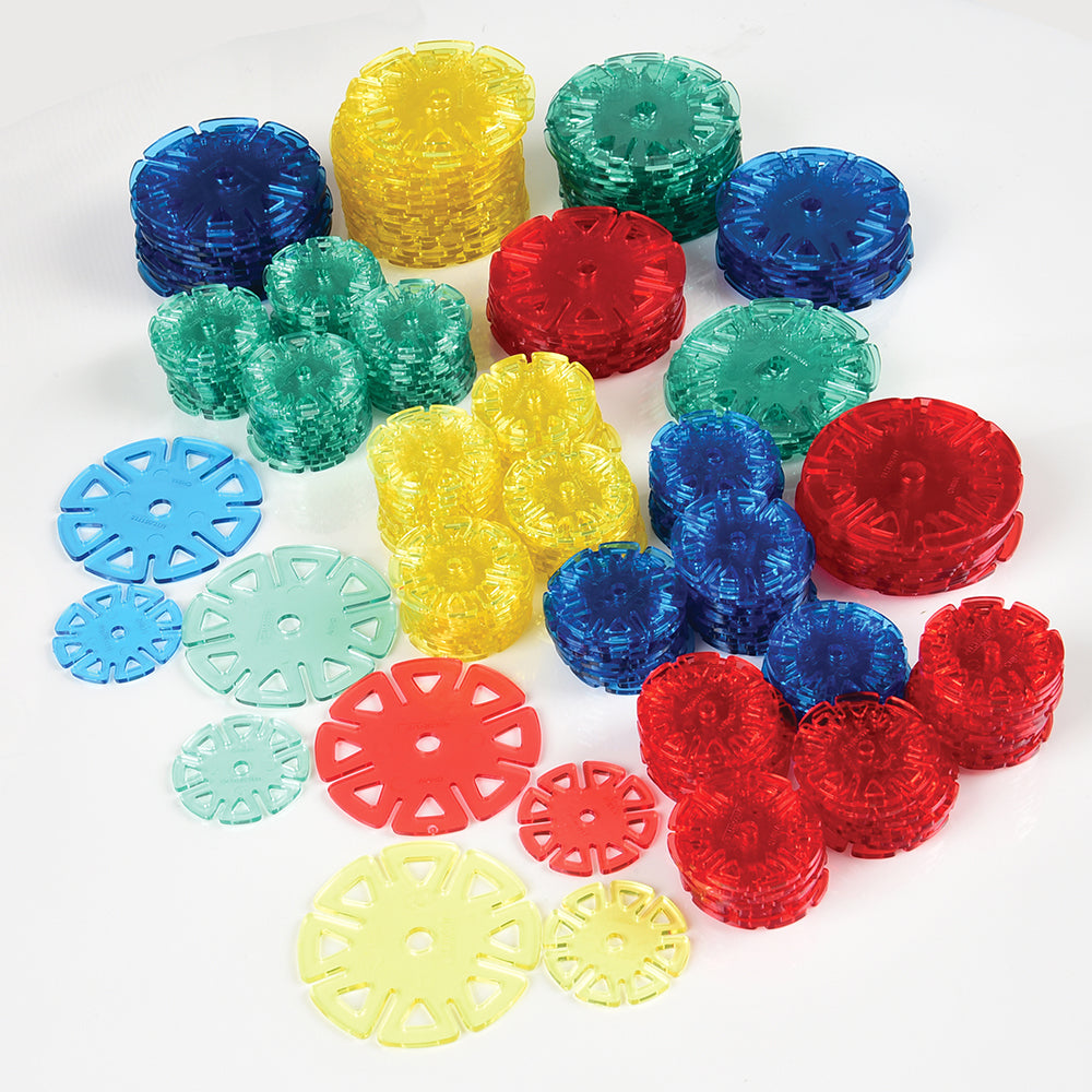 A collection of colorful plastic Crystal Connectors in various sizes arranged on a white surface.