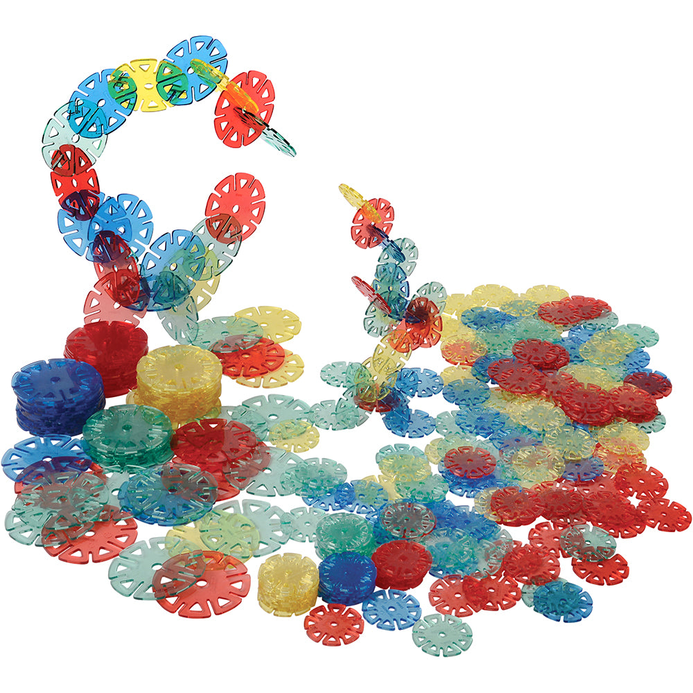 A collection of colorful plastic Crystal Connectors in various sizes stacked and arranged on white surface
