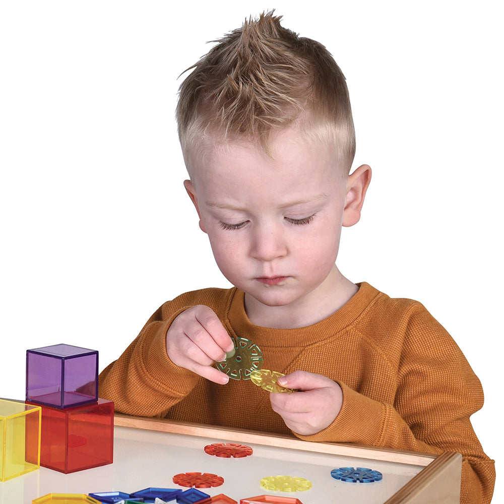 Kid connecting discs together on a white background