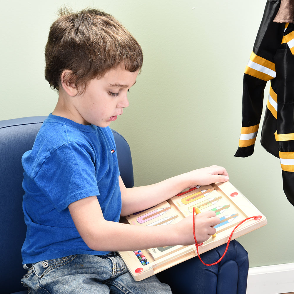 Kid Using Magnetic Color Matching Game in Classroom Setting