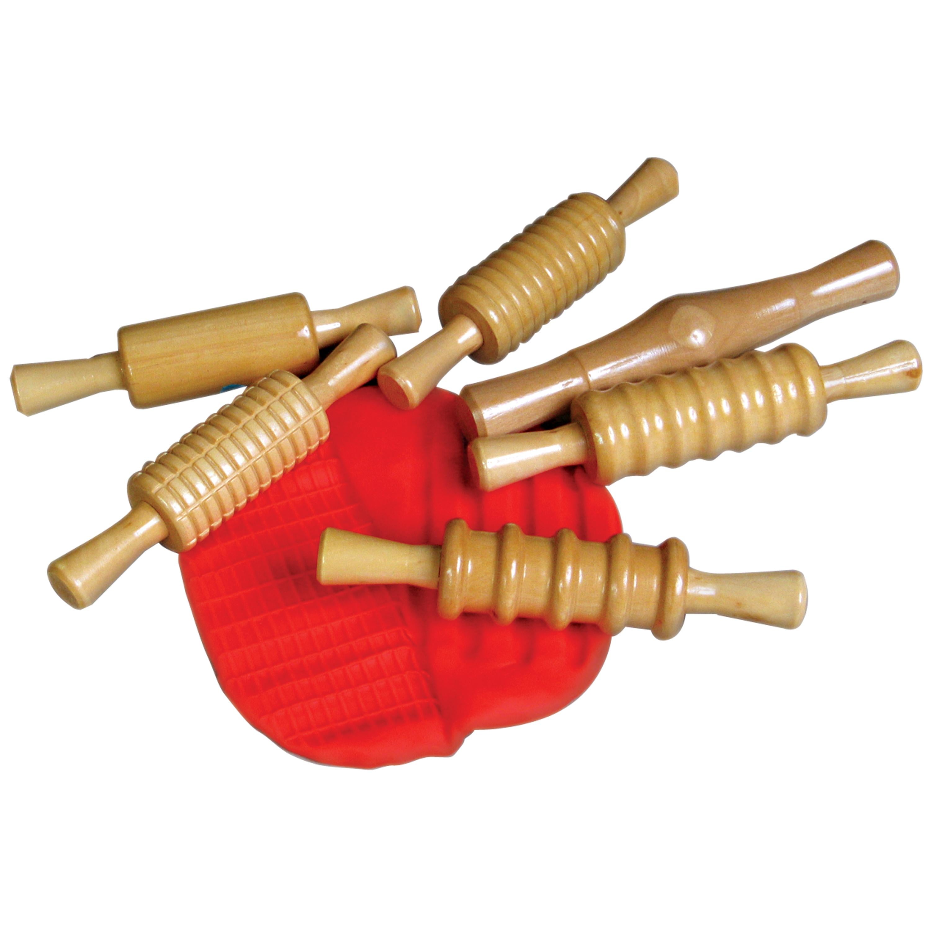 Set of wooden rolling pins on a red surface with a white background
