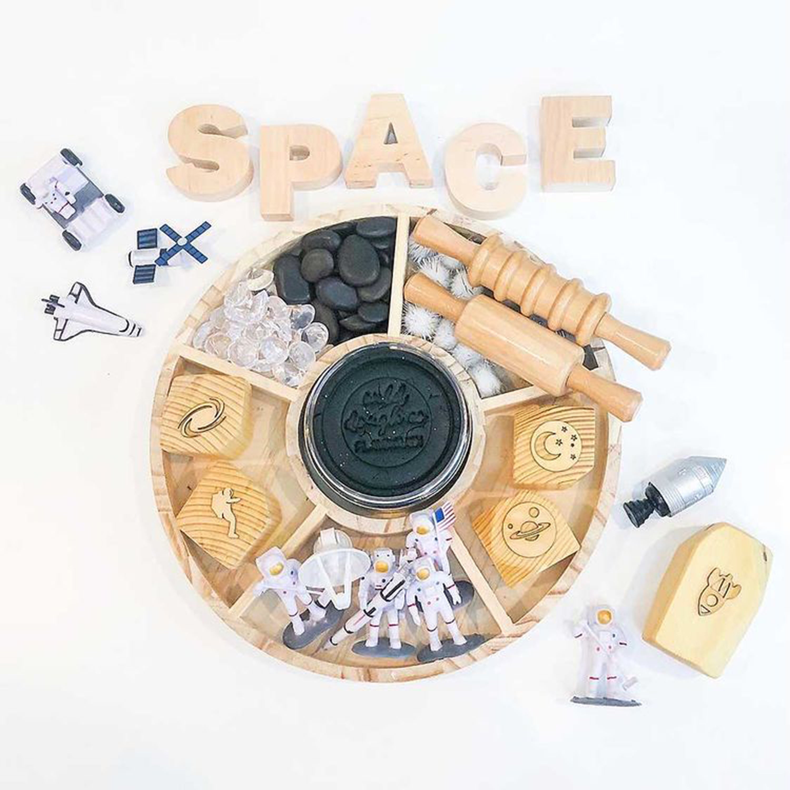 Wooden space-themed toy set with various space-related items on a white background