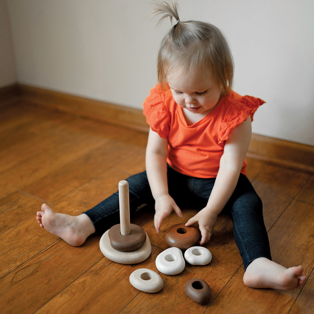 Toddler Interacting with Eco-Friendly Wooden Stacking Pebbles