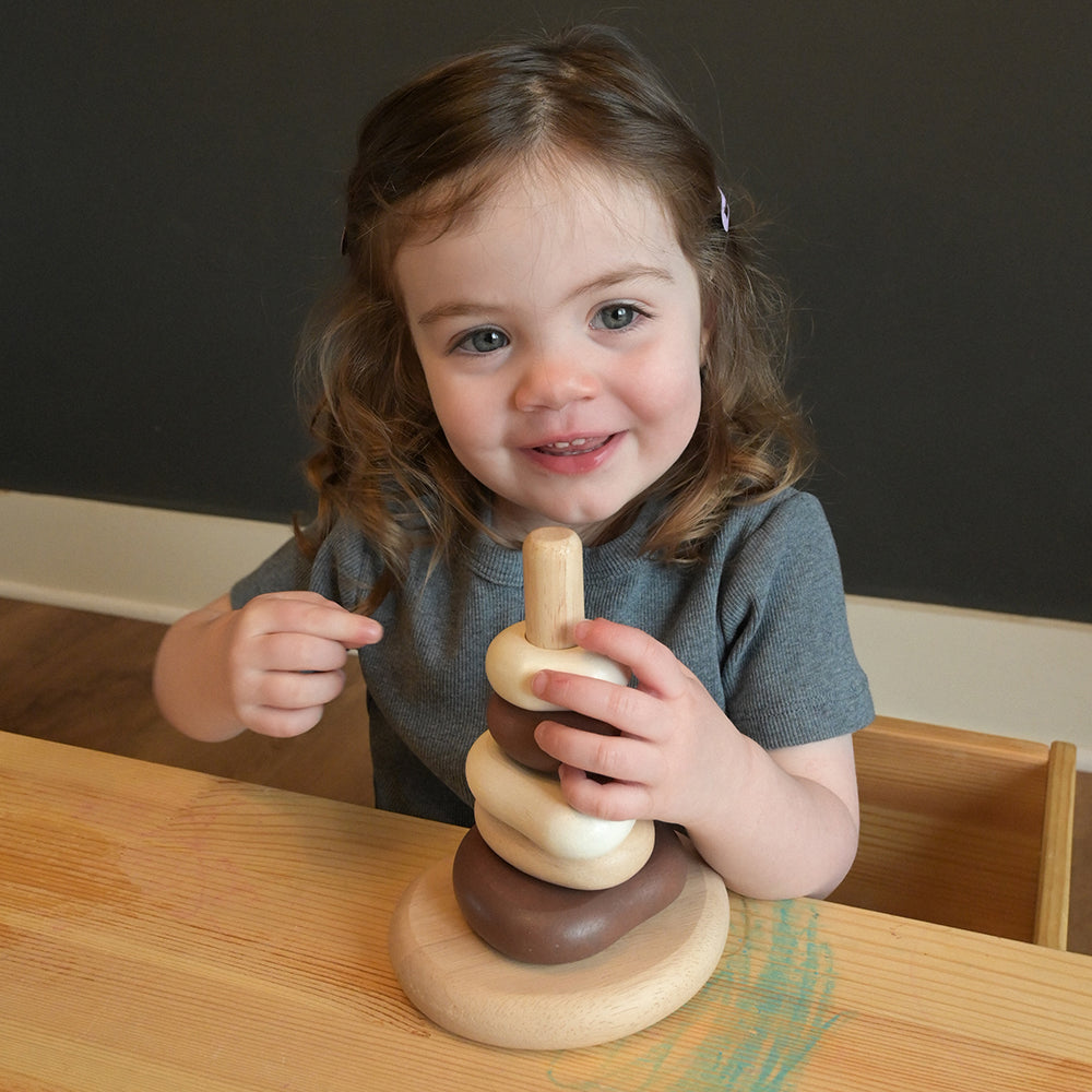 Toddler Having Fun with Eco-Friendly Wooden Stacking Pebbles