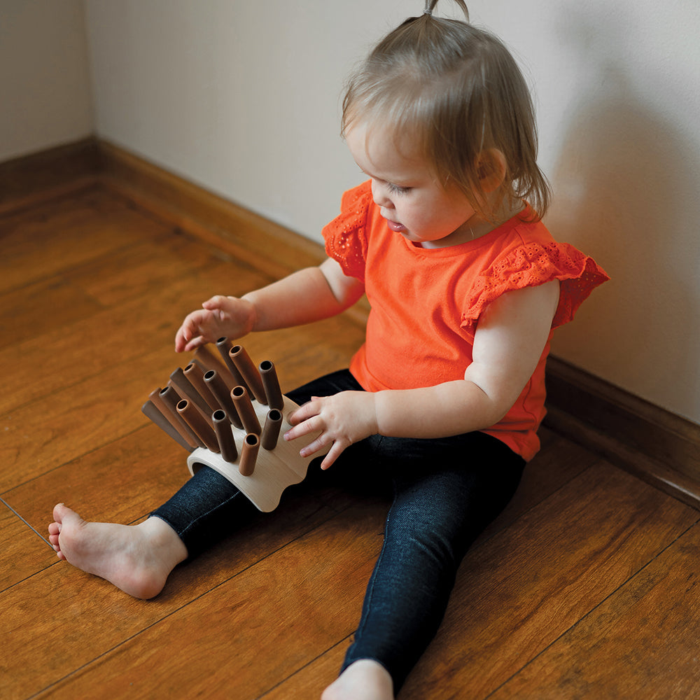 Toddler Interacting with Eco-Friendly Wooden Jiggle Sticks