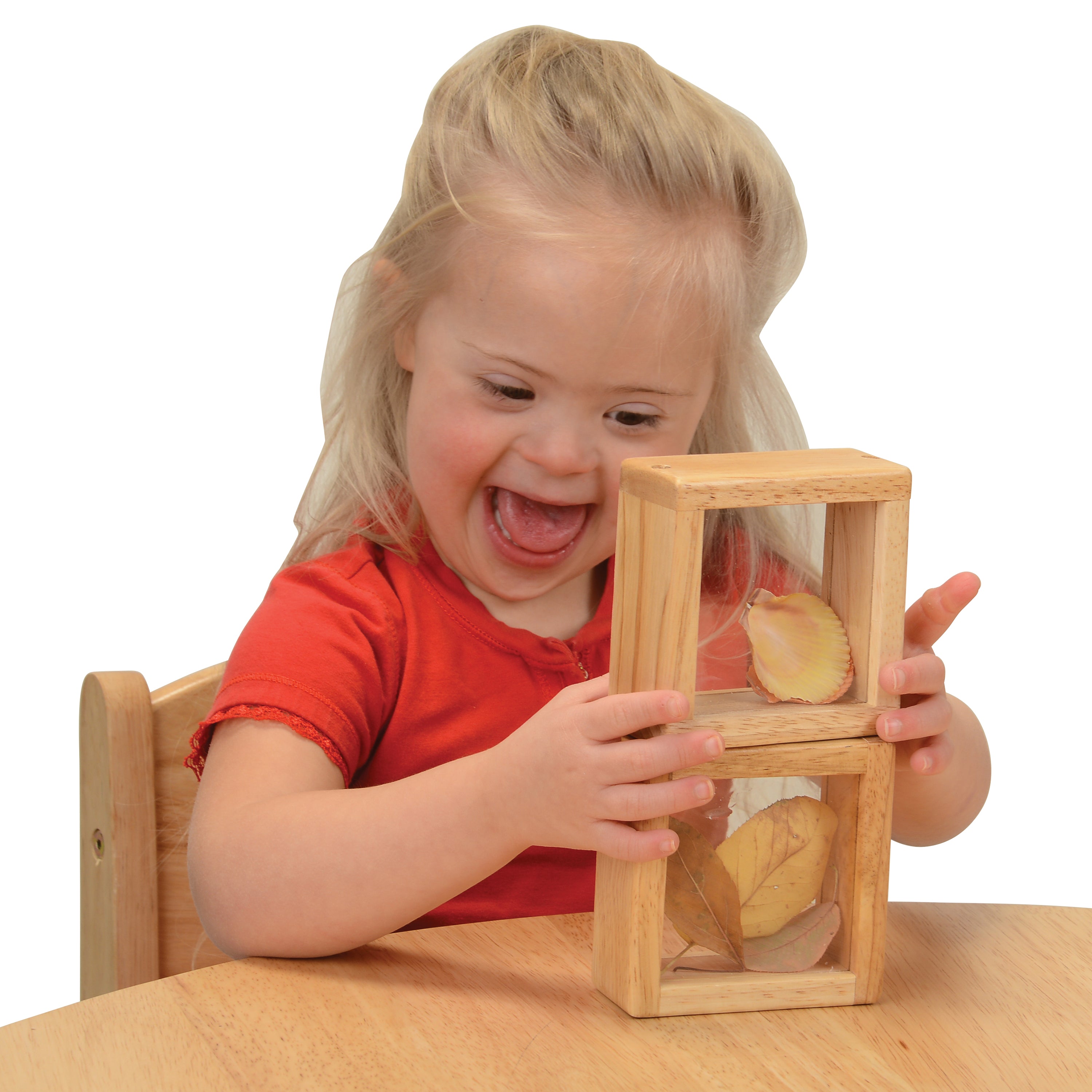 Child playing with a wooden puzzle toy on a white background