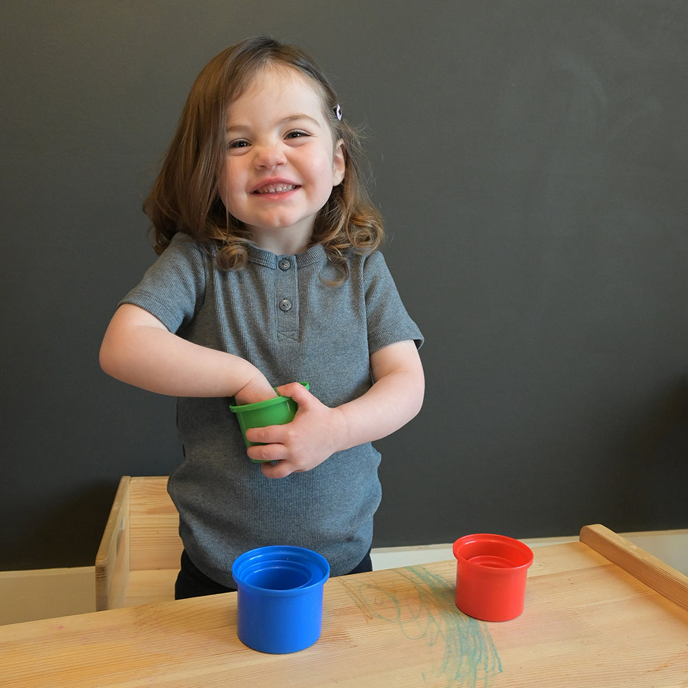 Kid in Classroom Sorting Nesting Cups By Color
