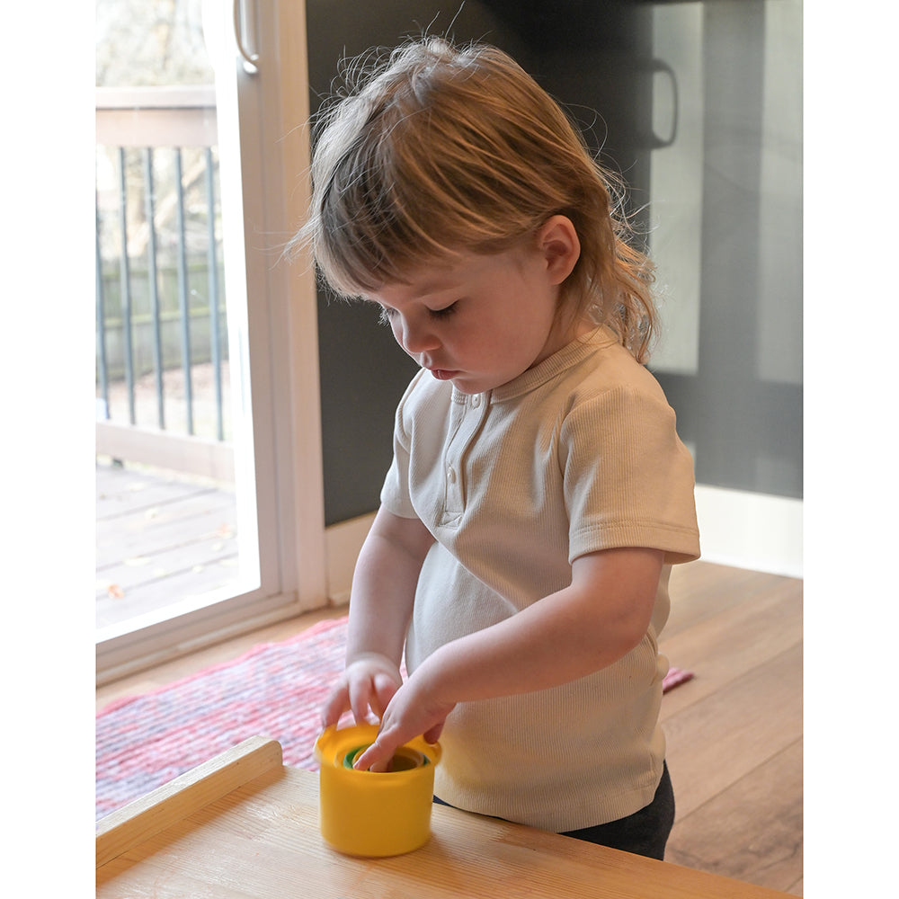 Toddler with Cups Nested Together