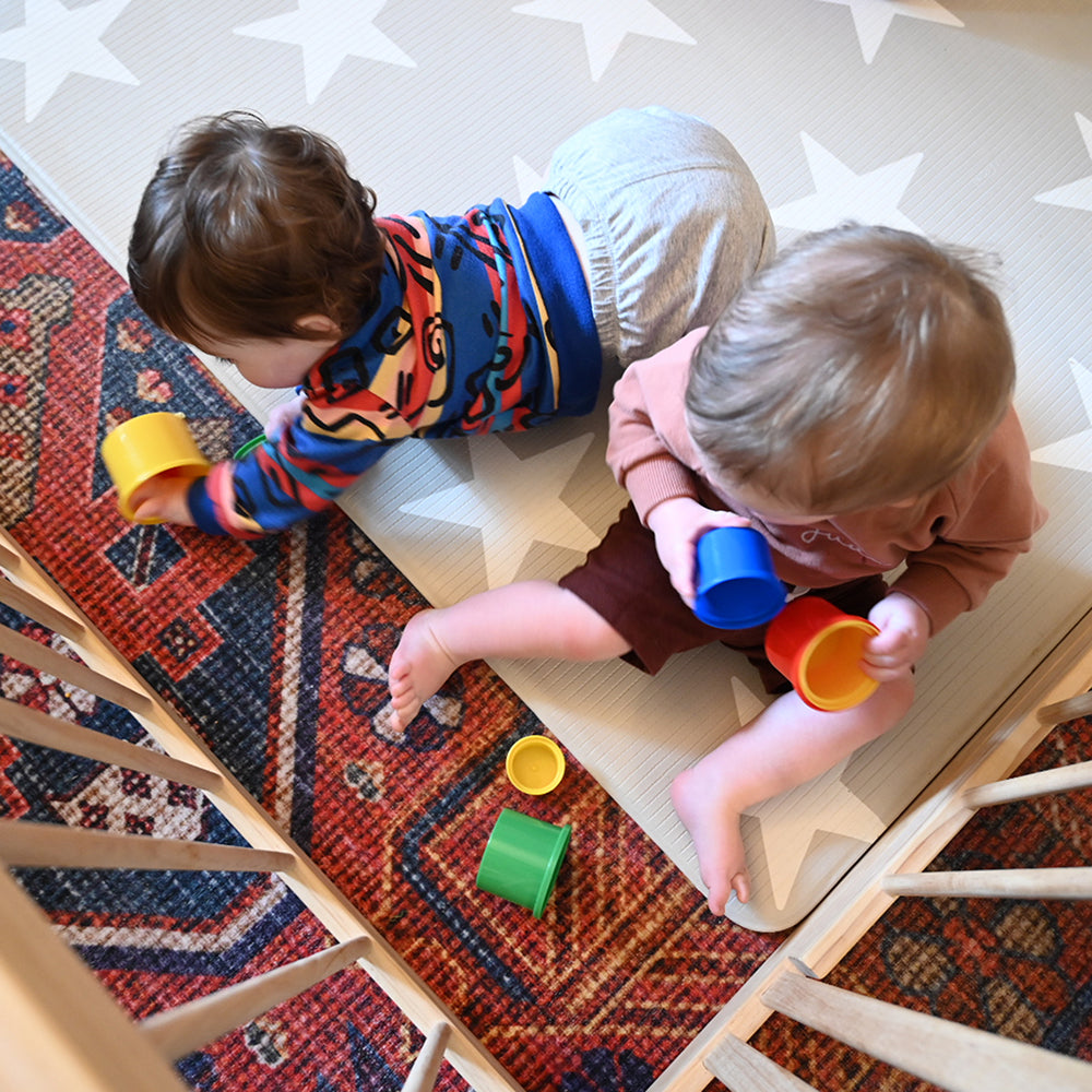 Two Toddlers Working on Hand-Eye Coordination with Nesting Cups