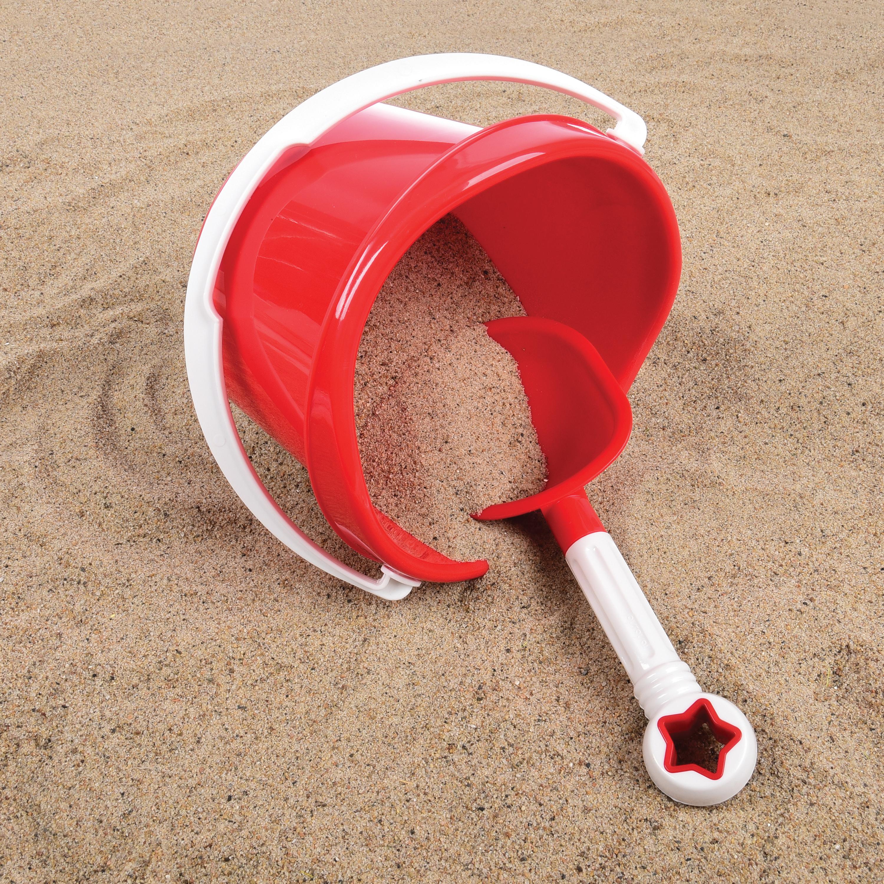 Red sand pail and shovel set on a sandy surface