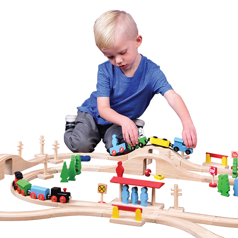 Kid Pushing Wooden Train Along Track