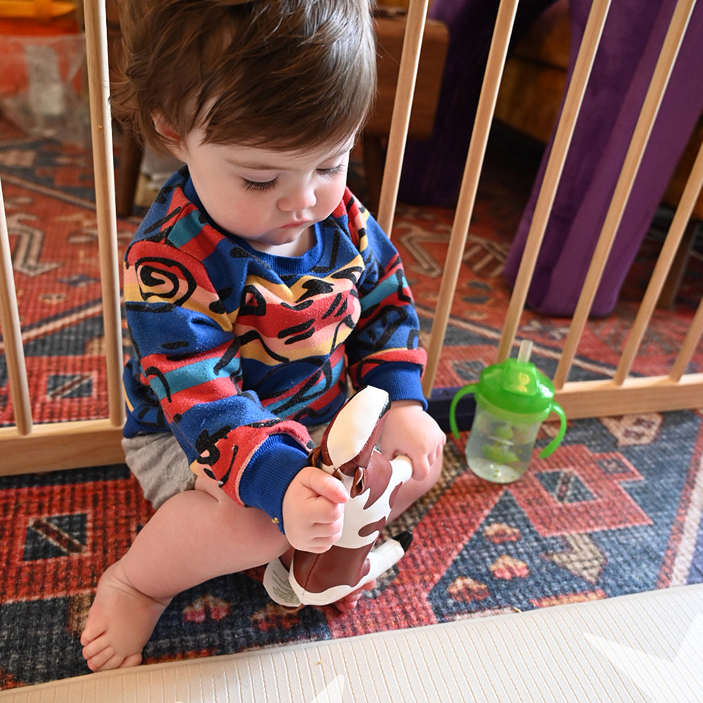 Toddler Being Entertained with Squishy Vinyl Horse