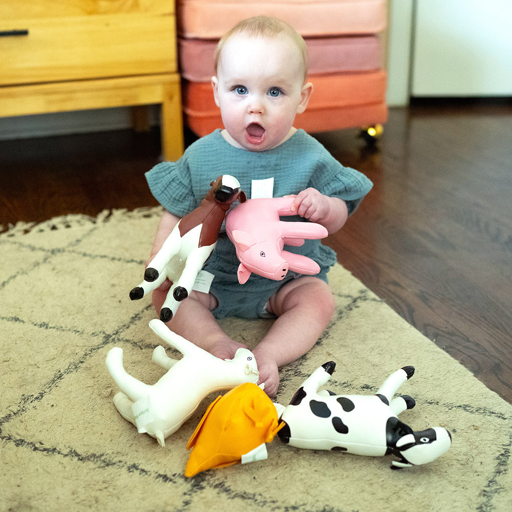 Baby Having Playtime with Soft Vinyl Farm Animal Play Set