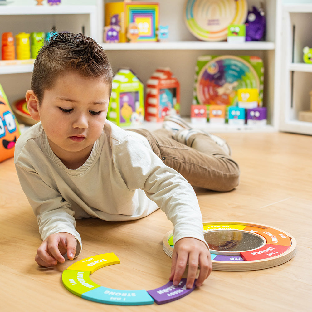 Child playing with educational toys on a wooden floor in a playroom.