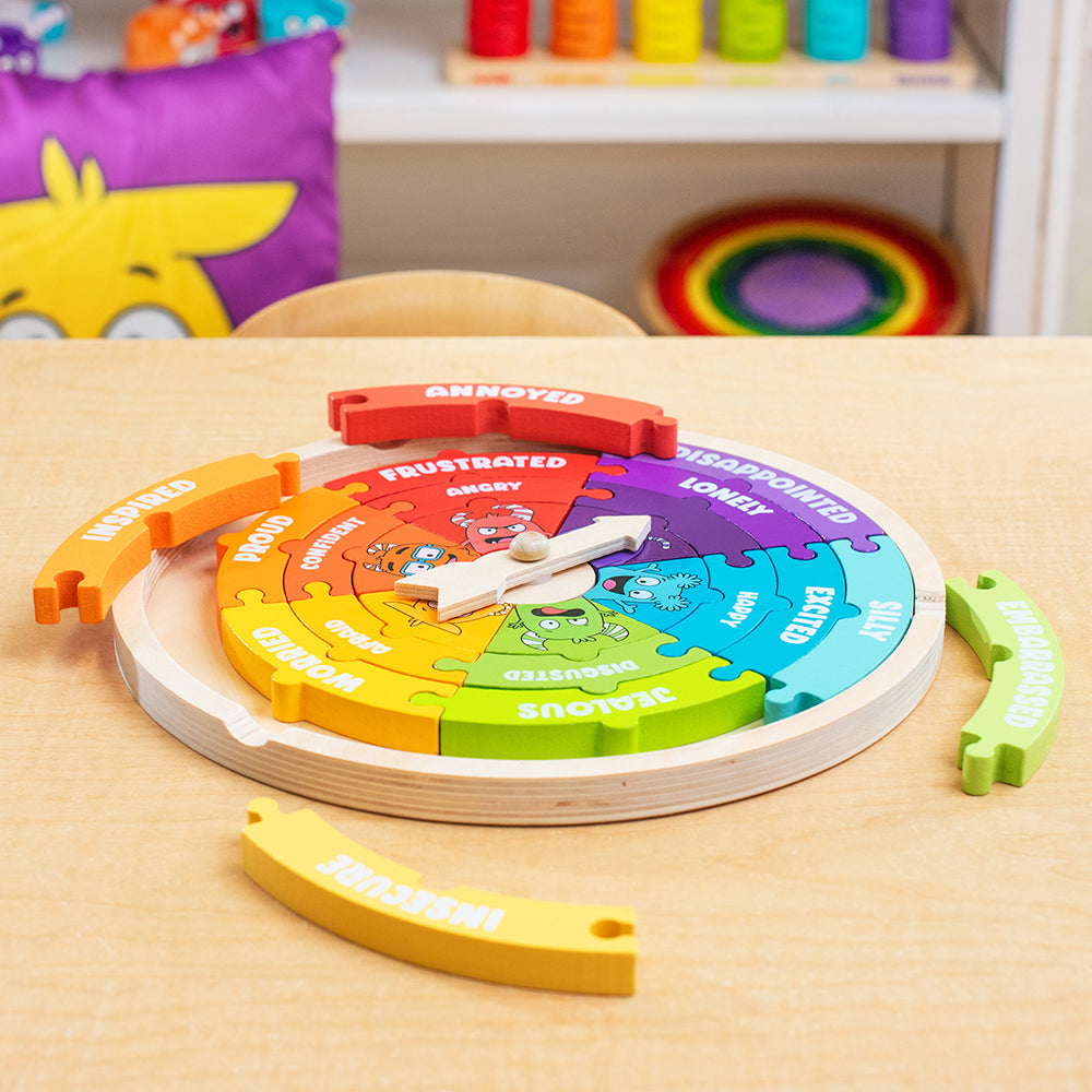 Colorful emotional regulation wheel toy on a wooden table with colorful background