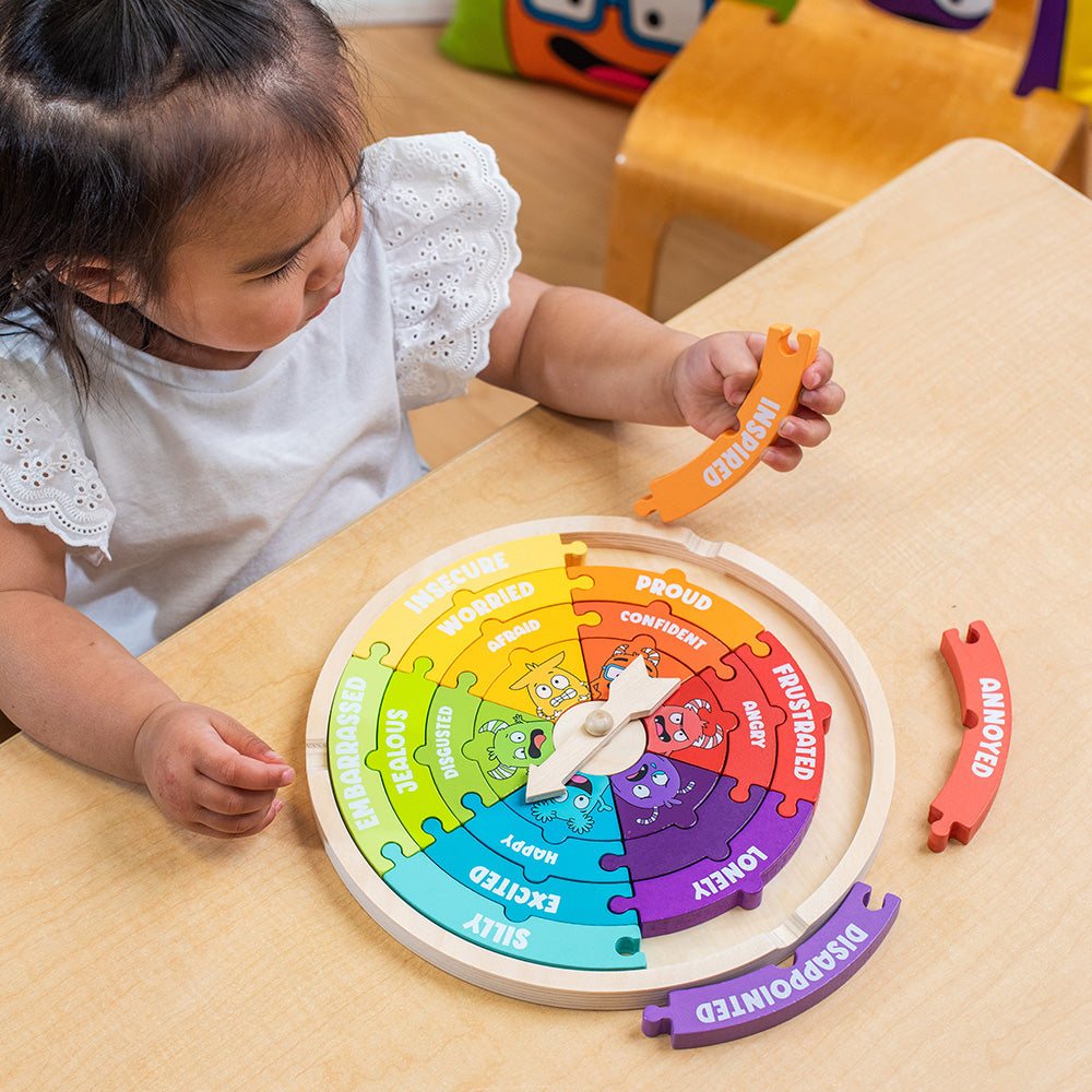Child playing with a colorful educational toy on a table