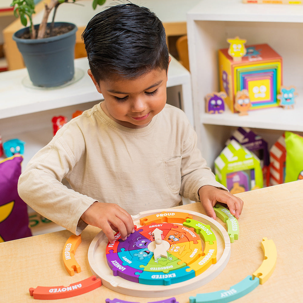 Child playing with a colorful educational toy at a table in a playroom.