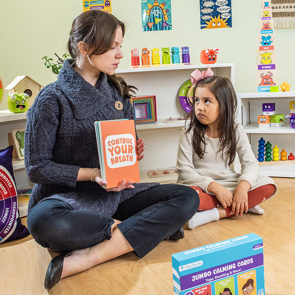 Woman and child in a classroom setting with educational materials