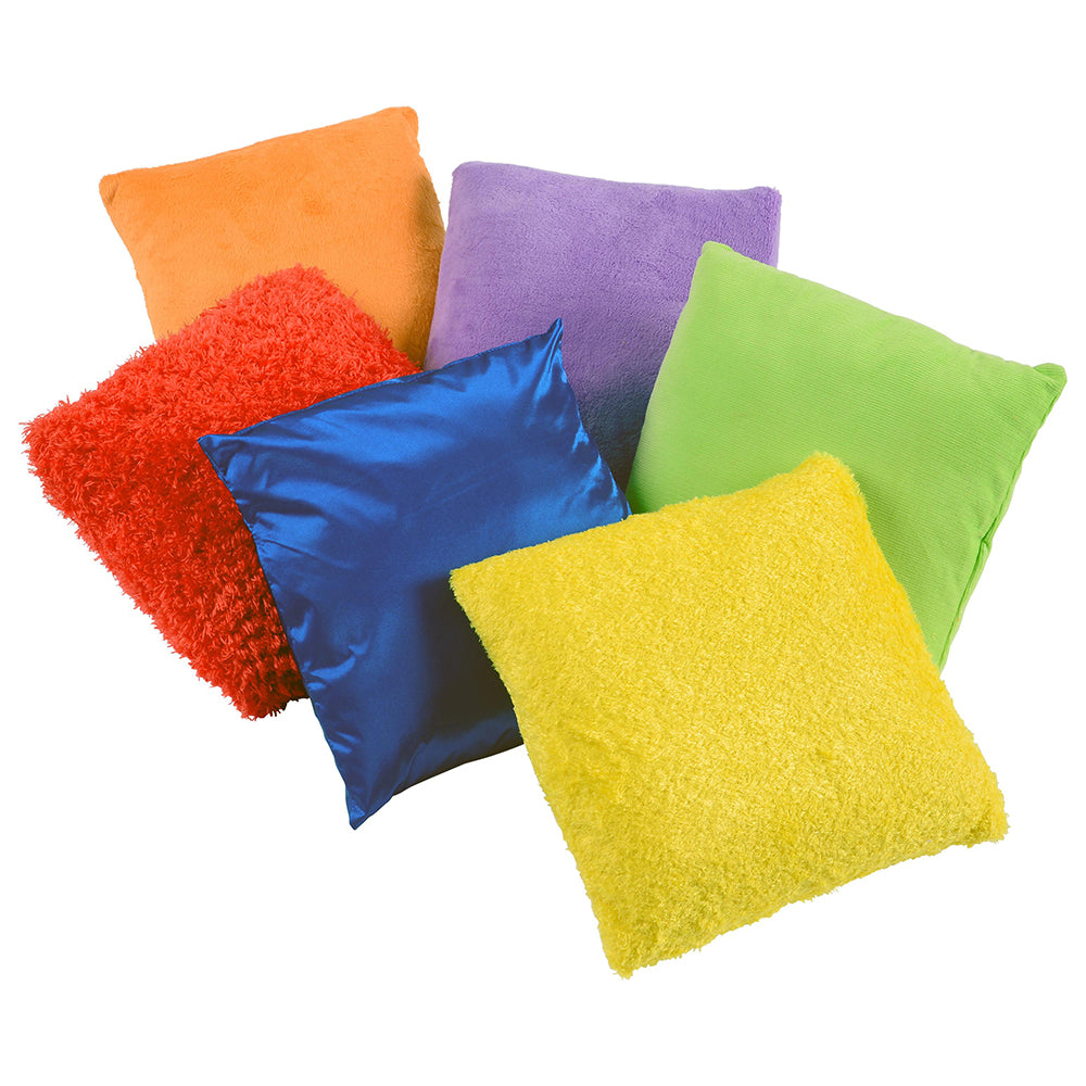 Colorful pillows in various textures and colors on a white background