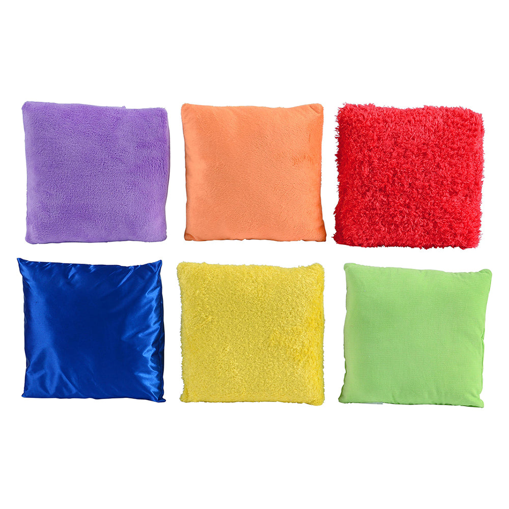 Six colorful pillows in different textures and colors on a white background