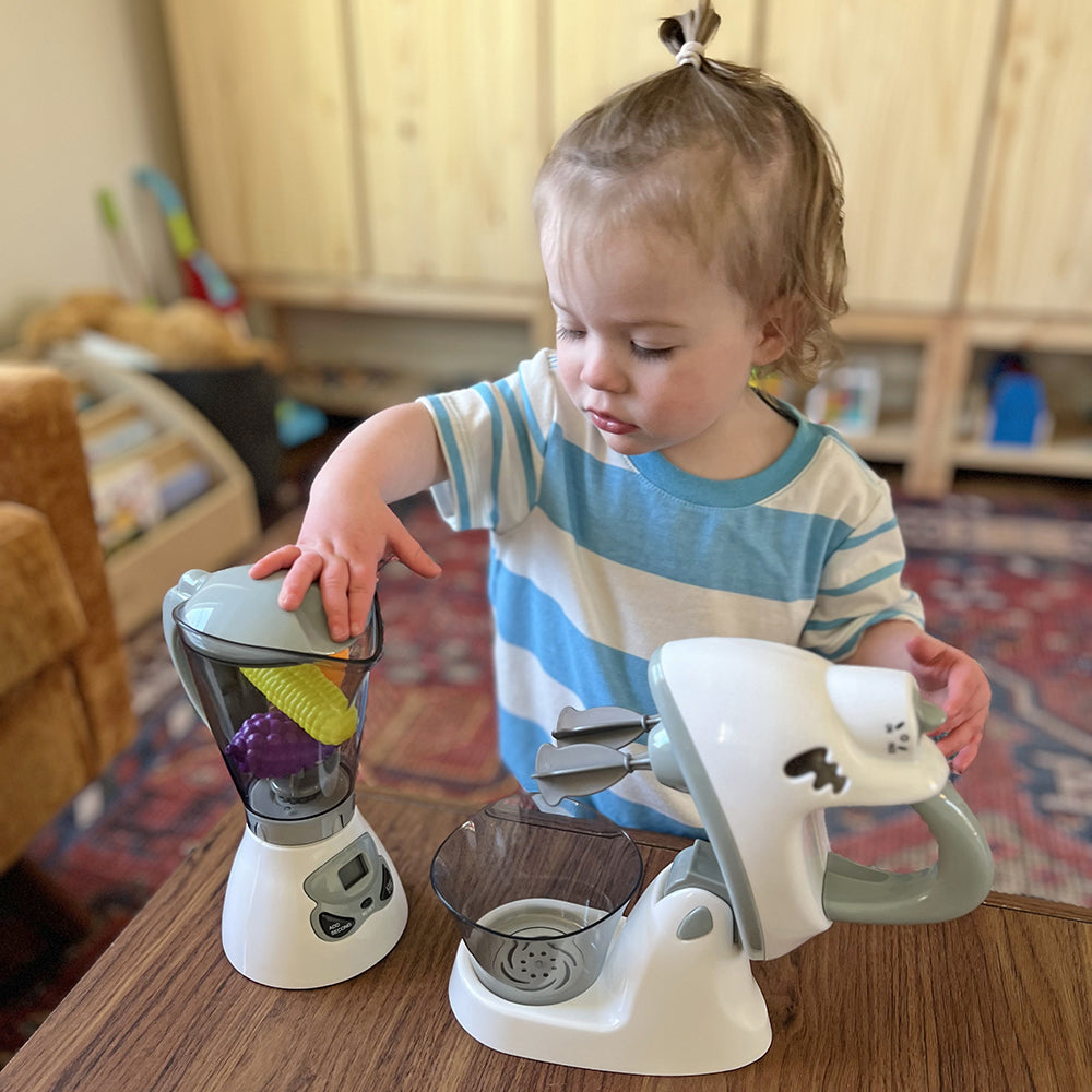 Toddler Adding Pretend Food To Toy Blender