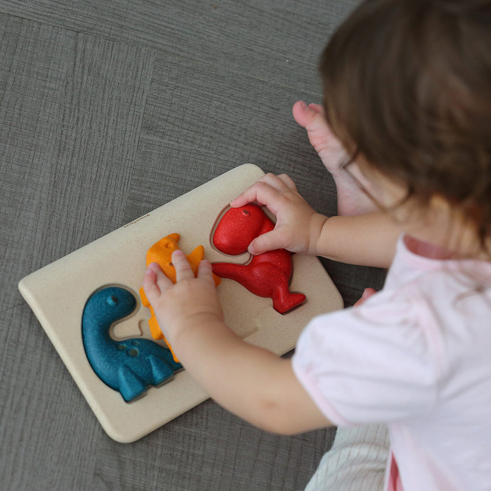 Toddler Playing with Chunky Dinosaur Puzzle Set