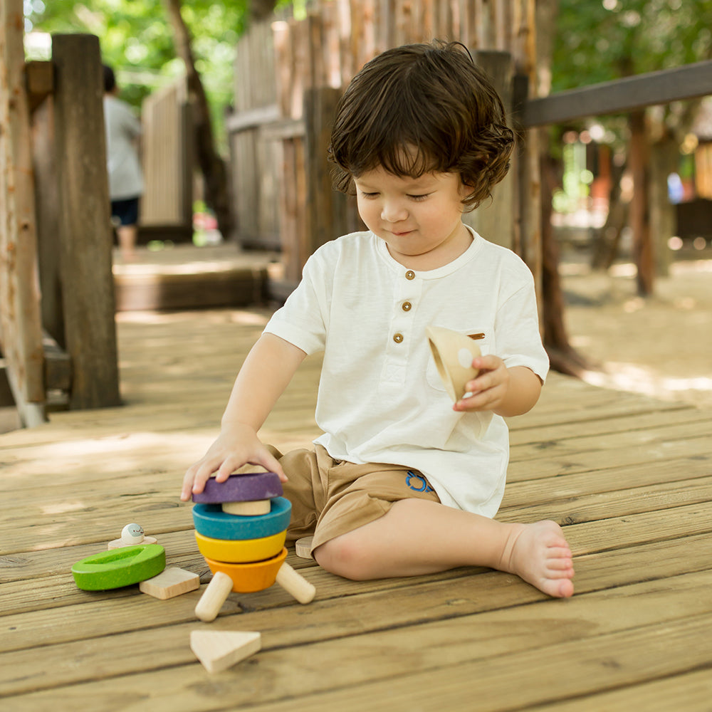 Toddler Interacting with Stacking Rocket Toy