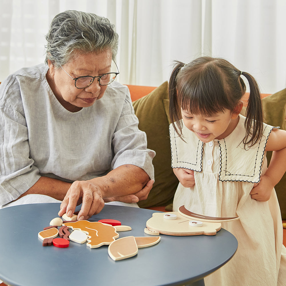 Adult and child building a fun face