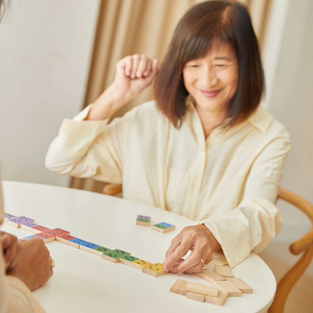 Laying down the happy emotion domino