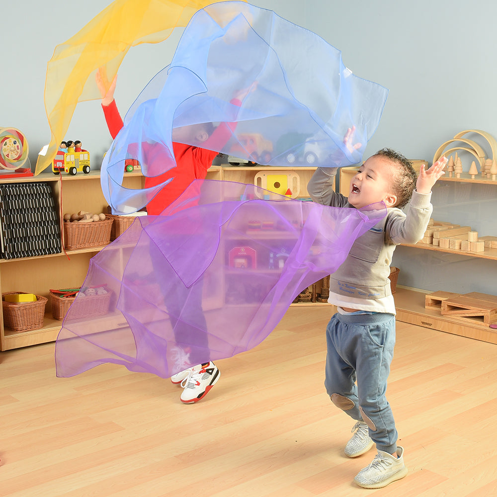 Toddlers Exploring Movement with Rainbow Scarves in the Classroom