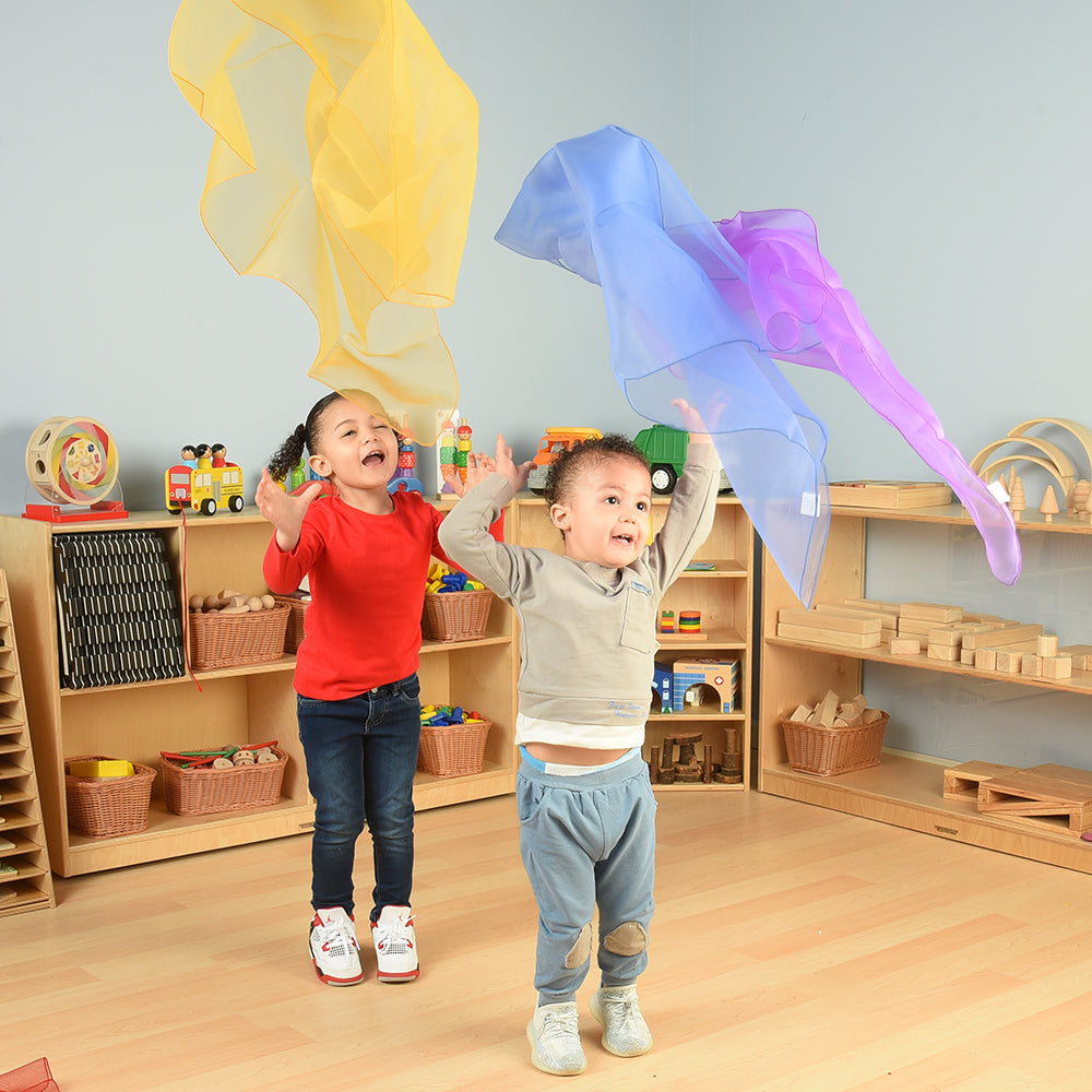 Toddlers Engaging with Rainbow Scarves in the Classroom