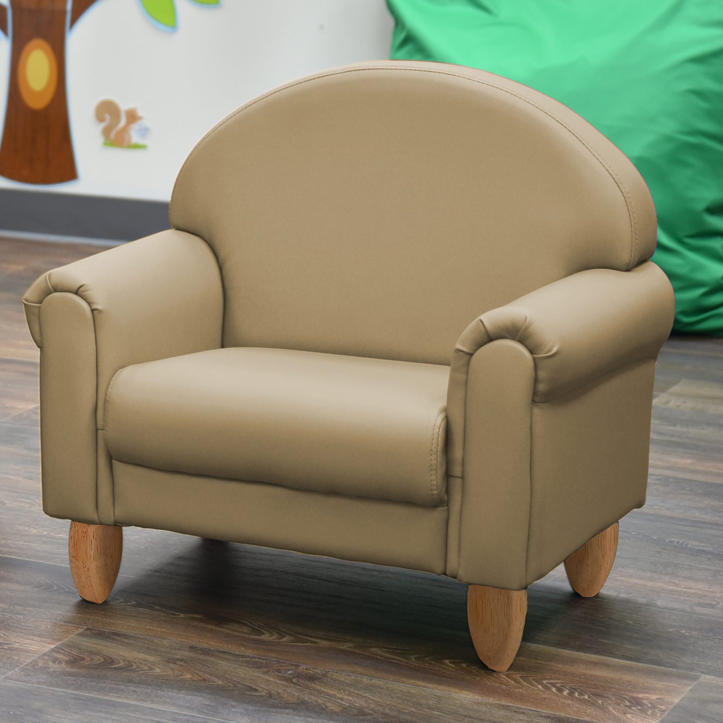 Beige children's chair on a wooden floor with a colorful background