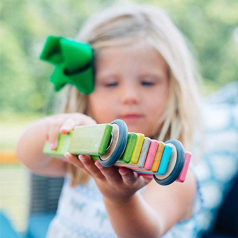 Kid Being Creative with 46-Piece Magnetic Wooden Building Set