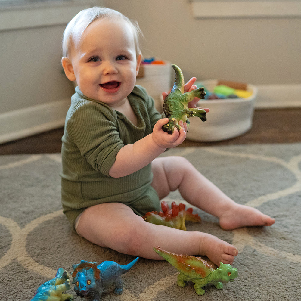 Toddler Engaging with Soft Squeezable Dinosaur Toys
